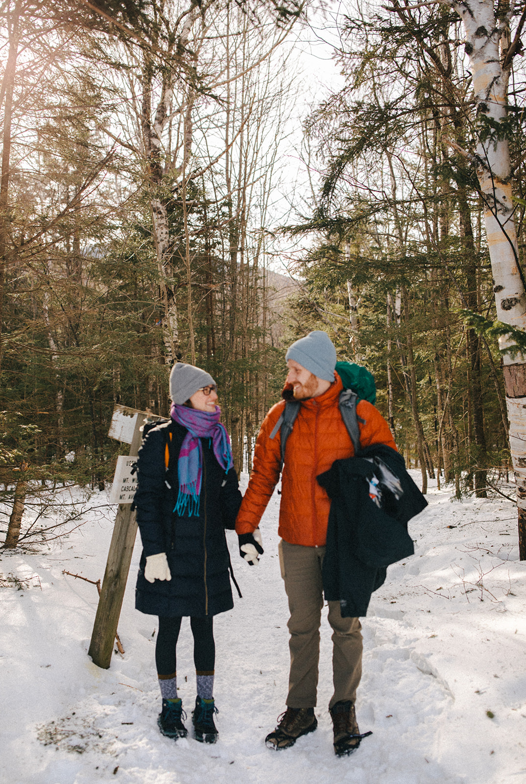 bride and groom hike together to their NH elopement site