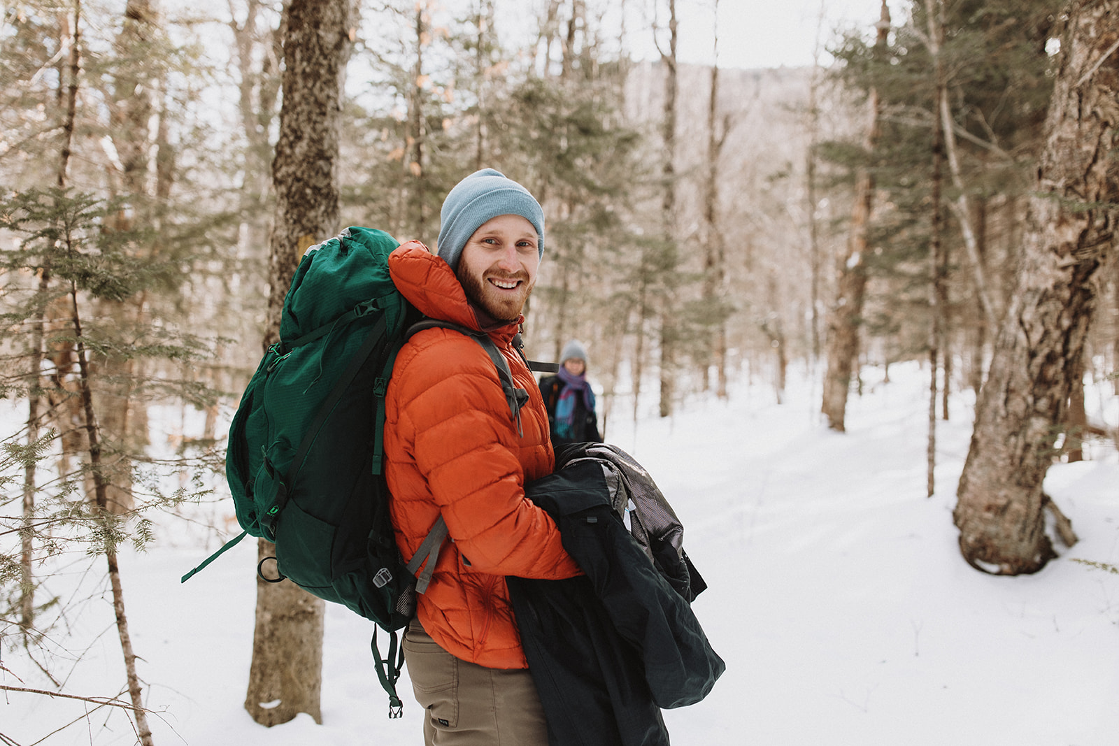 bride and groom hike together to their NH elopement site