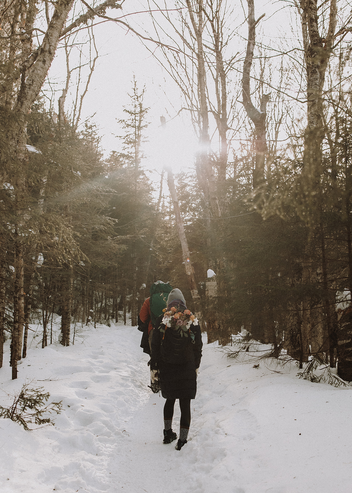 bride and groom hike together to their NH elopement site