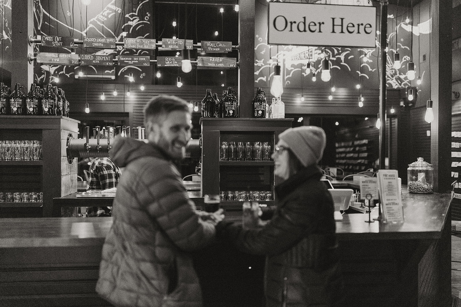 beautiful bride and groom share a beer after their dreamy New Hampshire wedding day