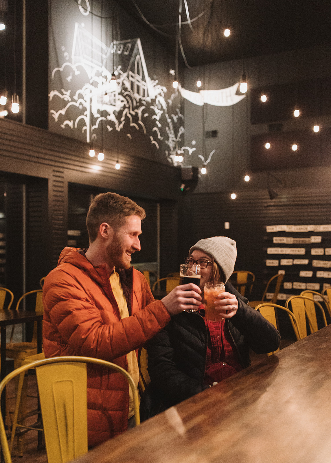 beautiful bride and groom share a beer after their dreamy New Hampshire wedding day