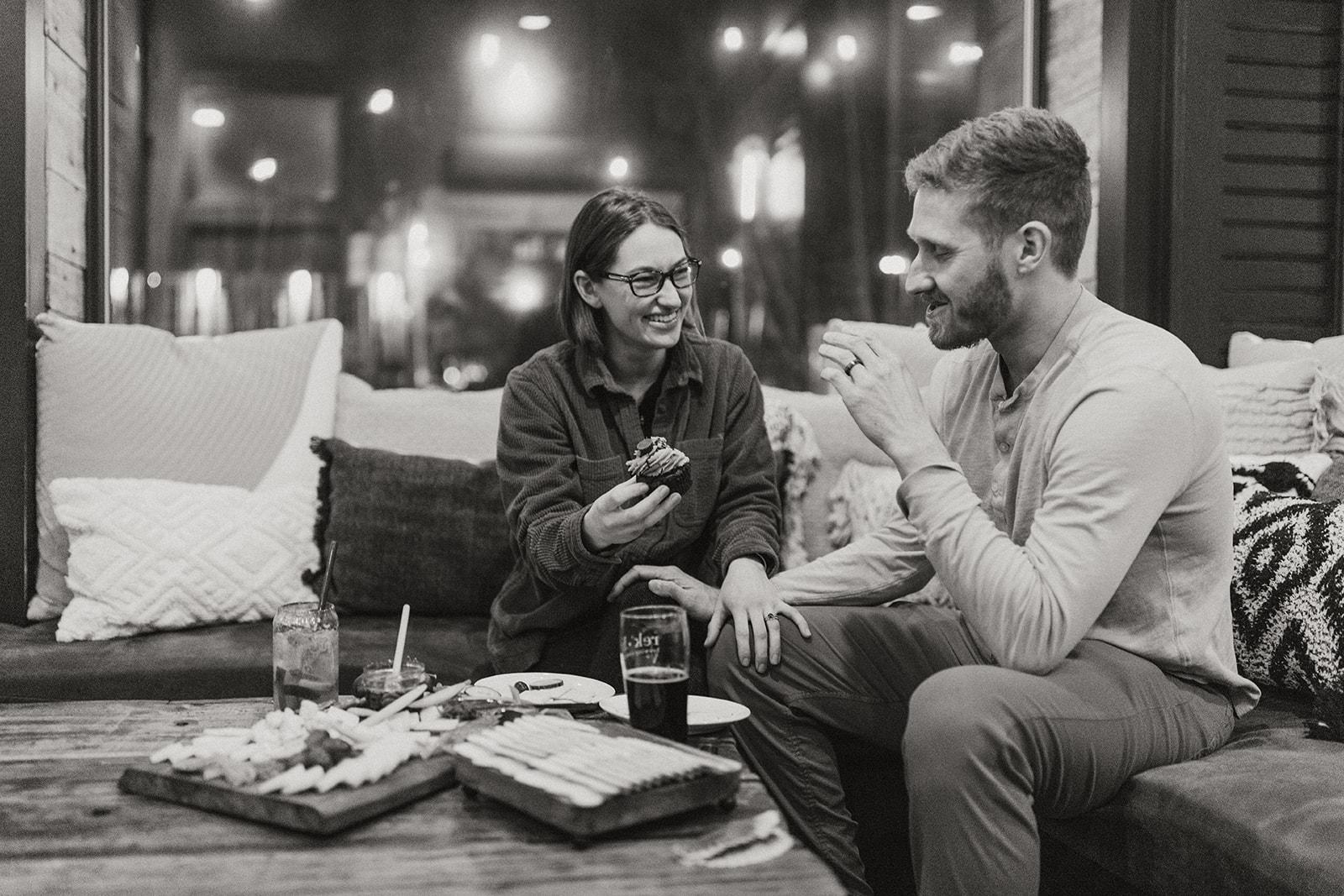 beautiful bride and groom share a beer after their dreamy winter elopement in nh