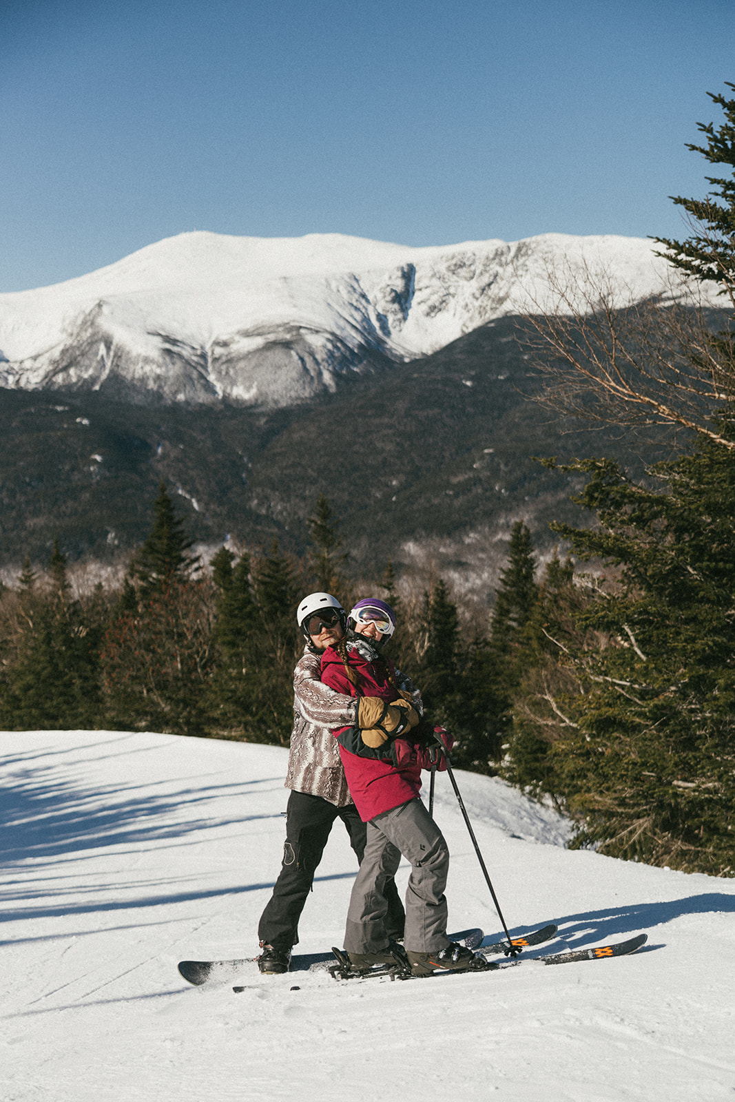 creative winter skiing engagement photos in the White Mountains