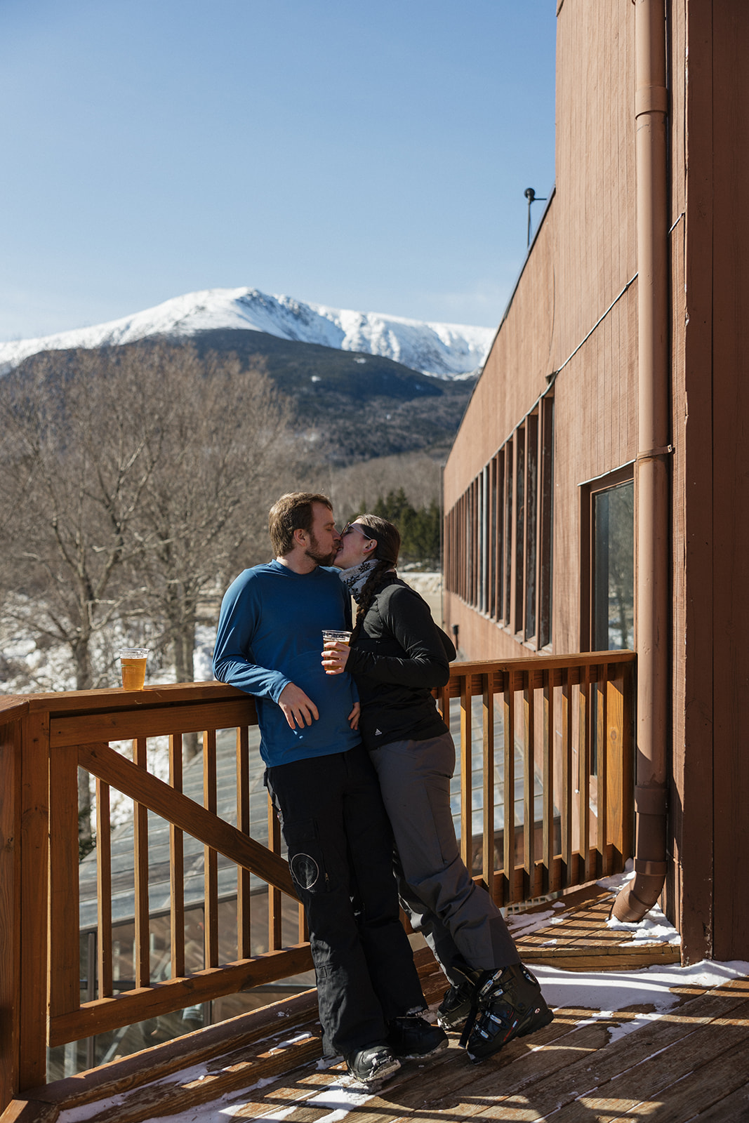 beautiful couple pose together during with the White Mountains in the background