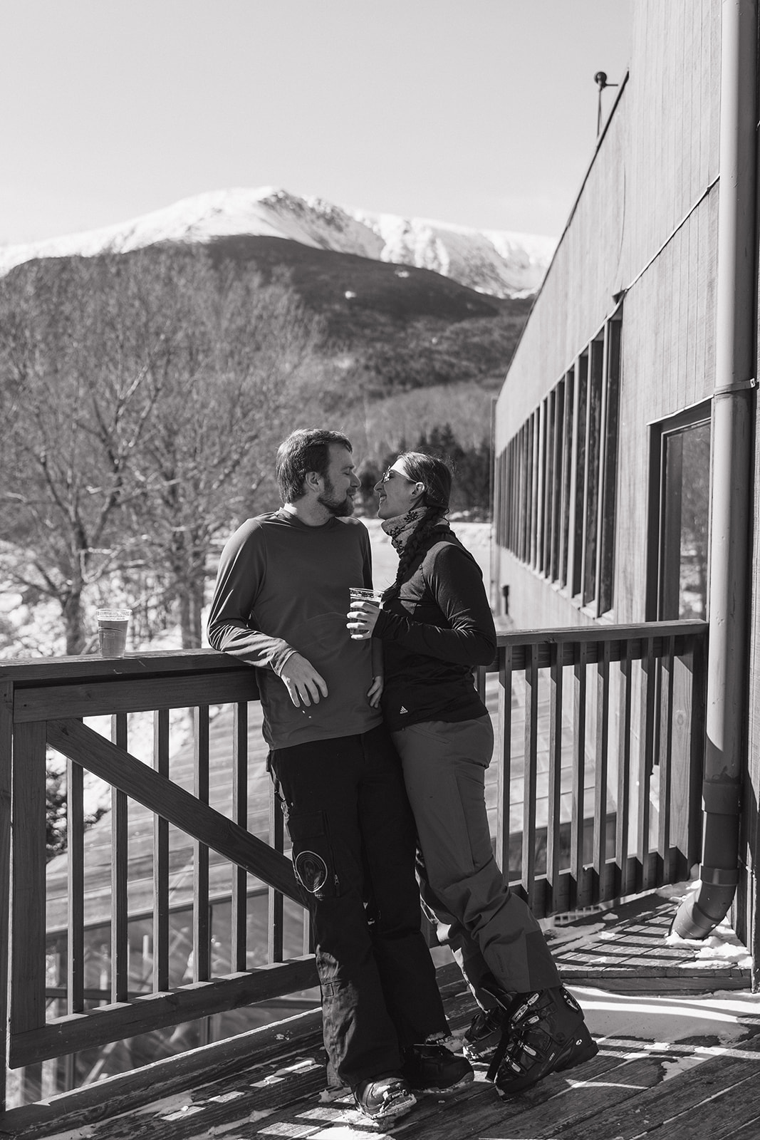 beautiful couple pose together during with the White Mountains in the background