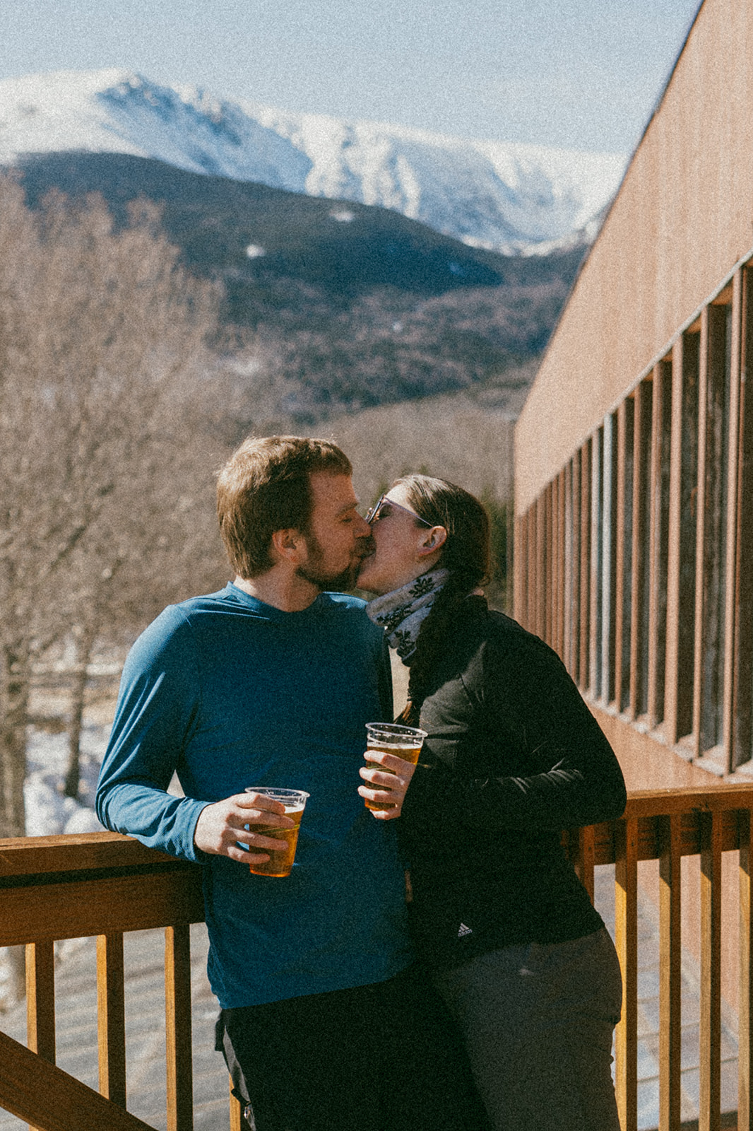 beautiful couple pose together during with the White Mountains in the background