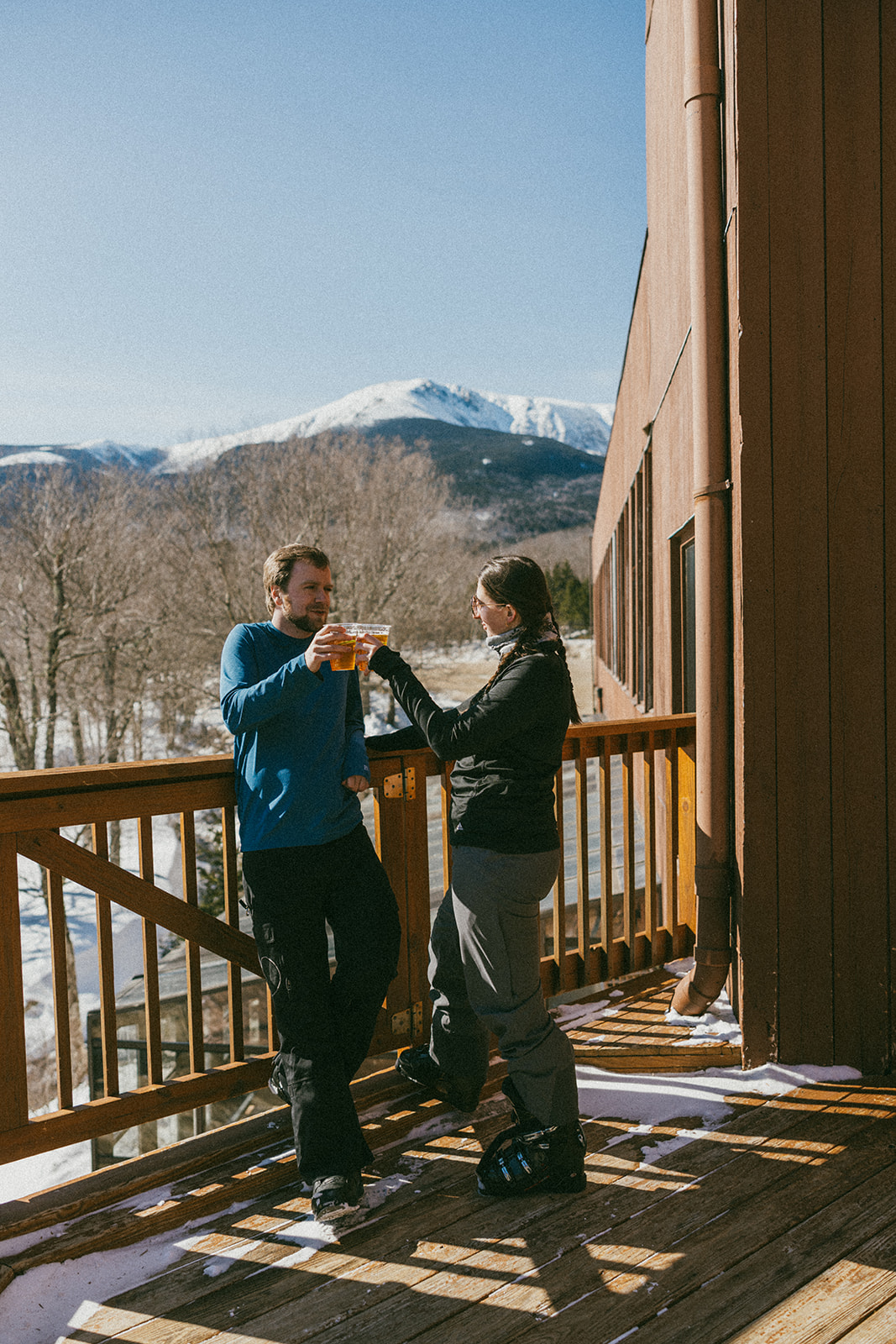 beautiful couple pose together during with the White Mountains in the background