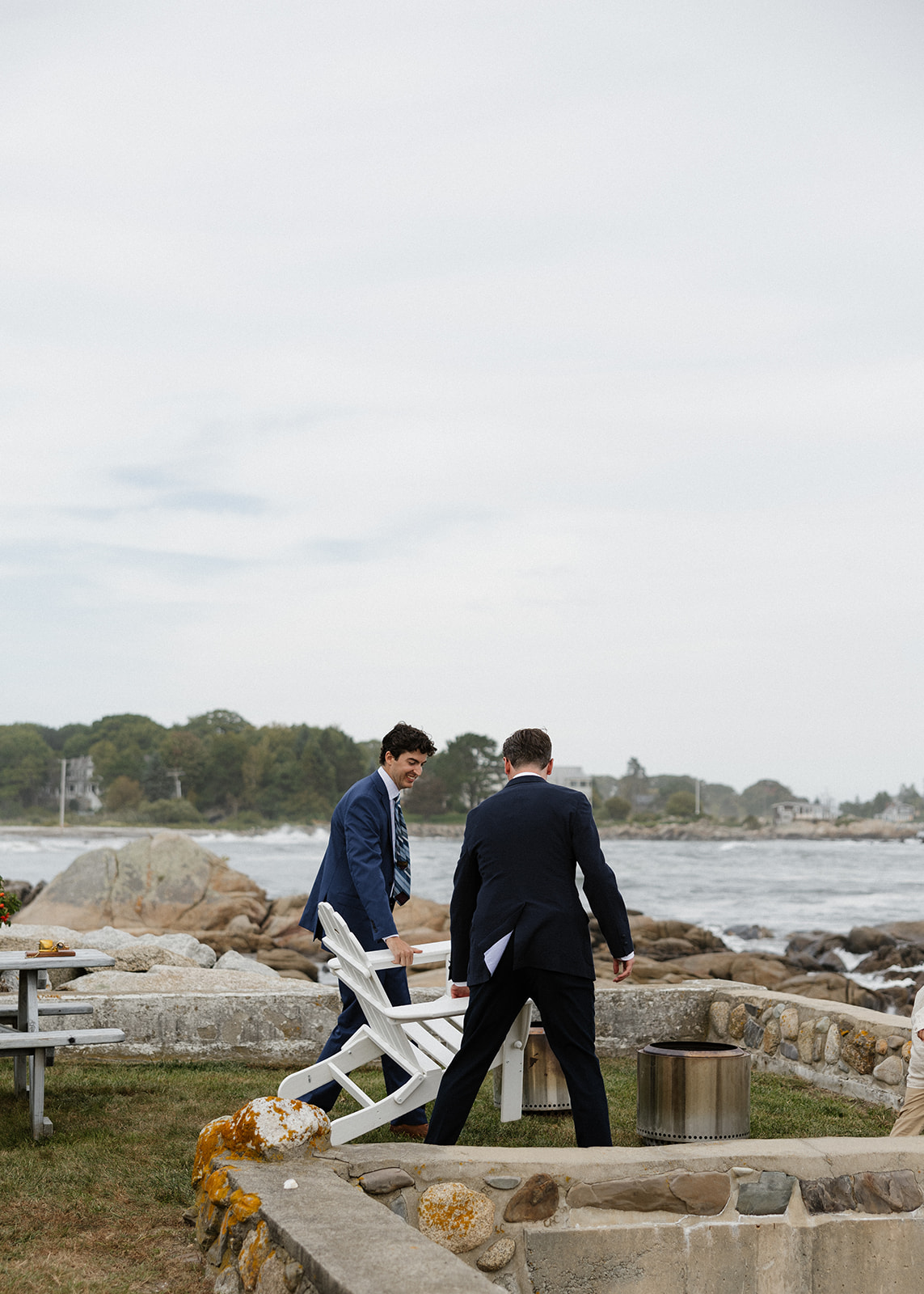 Friends helping set up an intimate wedding day in coastal maine 
