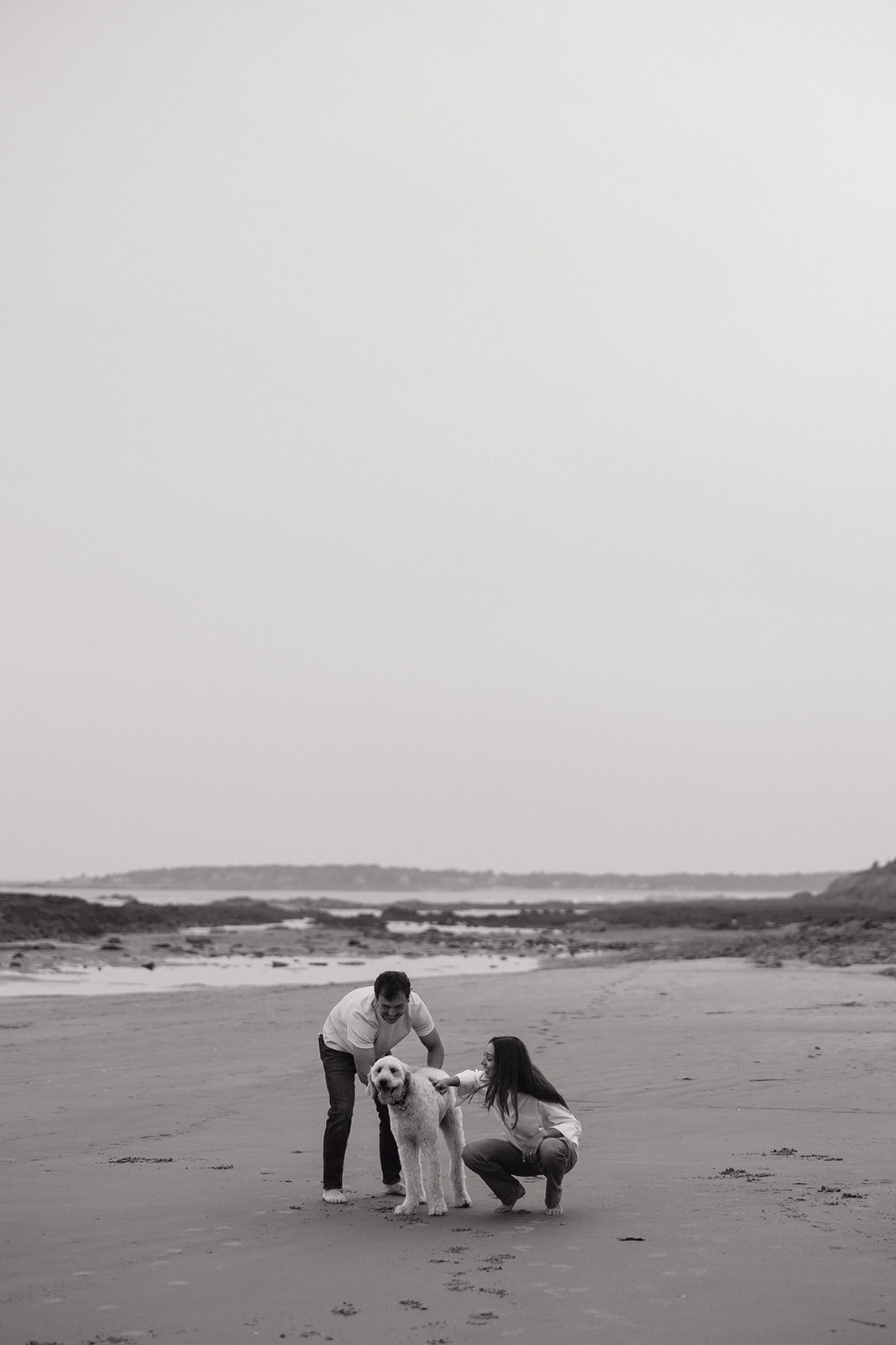 beautiful couple pose with their dog