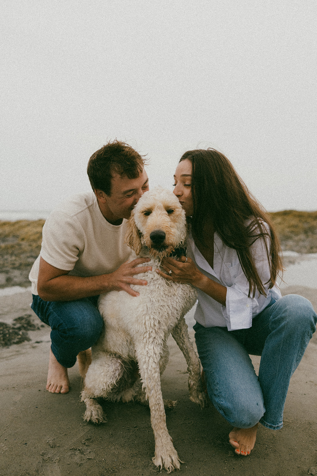 beautiful couple pose with their dog