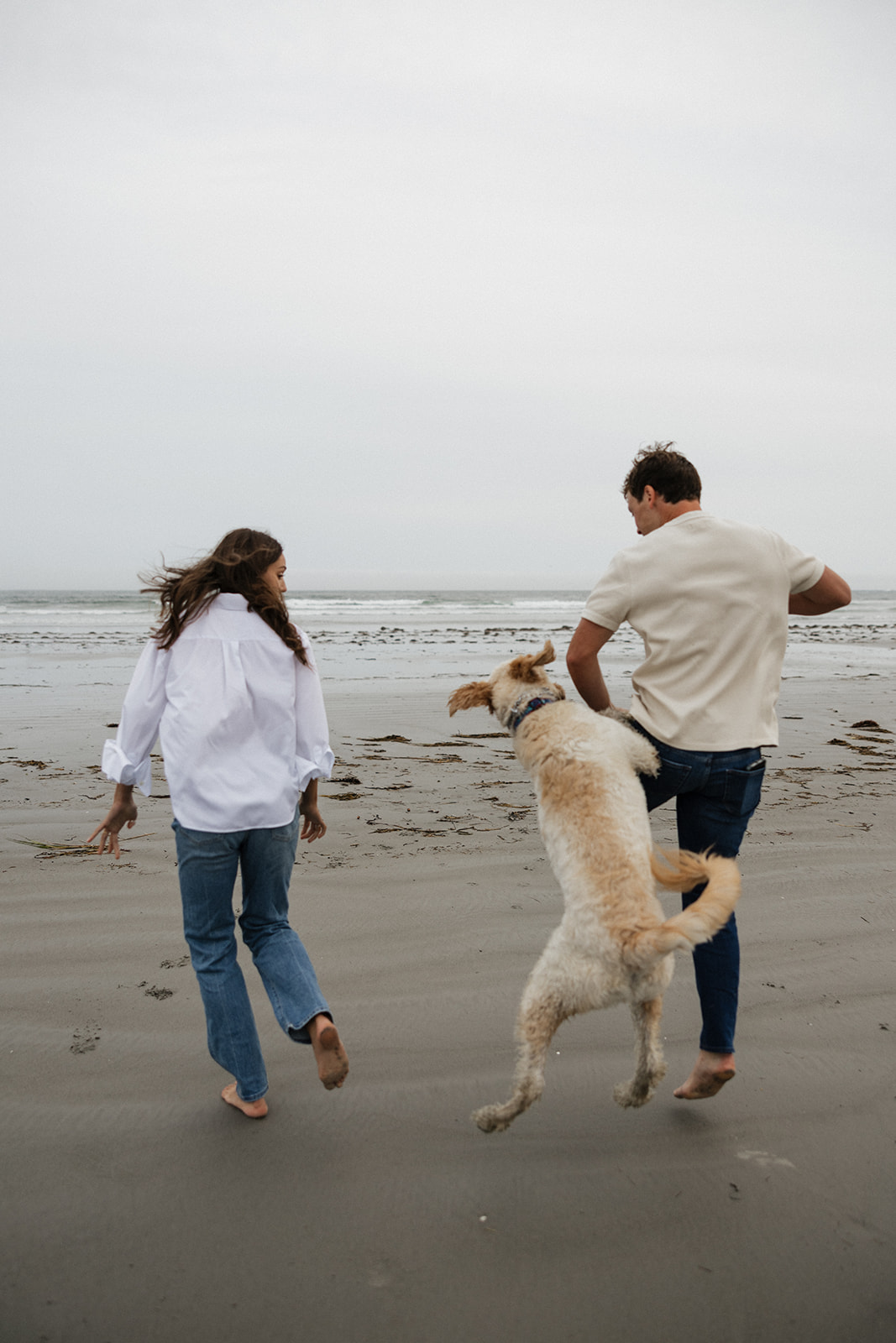 beautiful couple pose with their dog