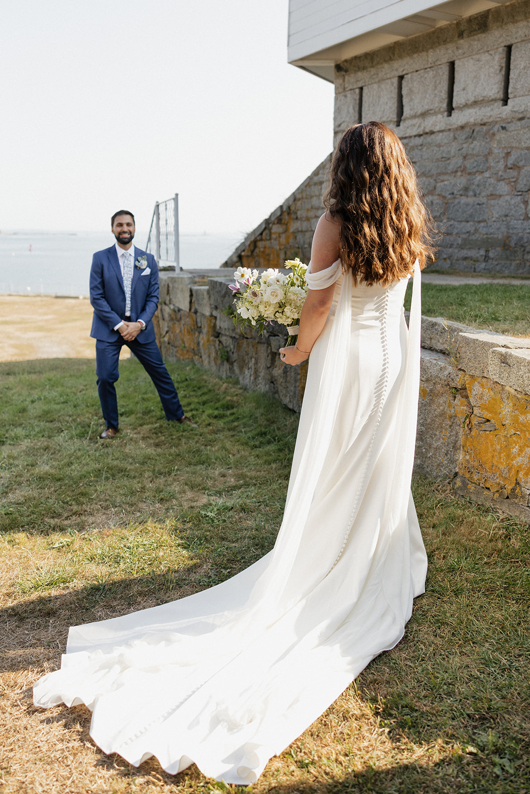 Elegant southern Maine wedding photography of a bride and groom first look at Pepperrell Cove from Erica Warren Photography