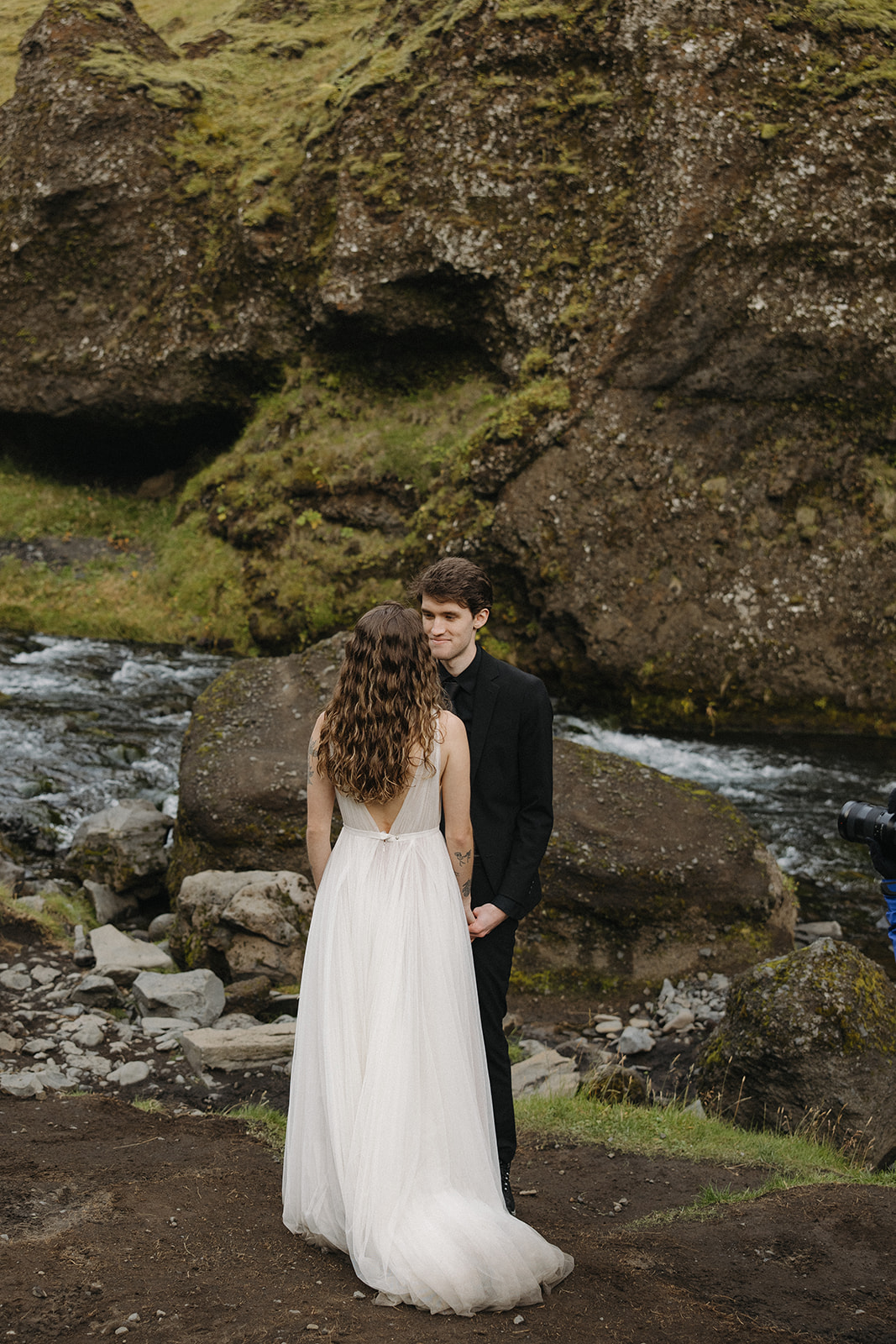 bride and groom take a moment to pose together in the Icelandic valley