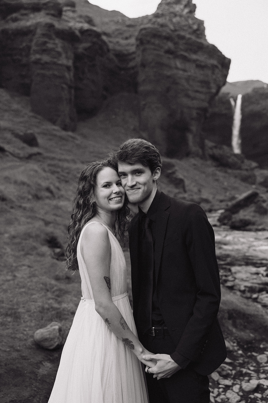 bride and groom take a moment to pose together in the Icelandic valley