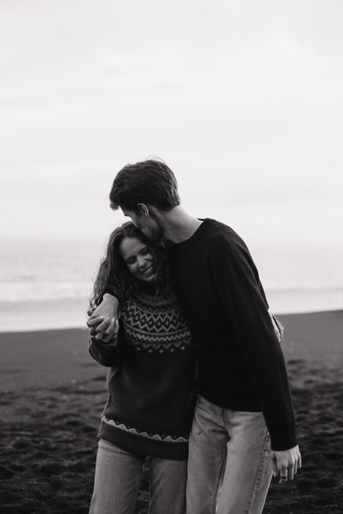 stunning couple share an intimate moment on the icelandic beach at sunset