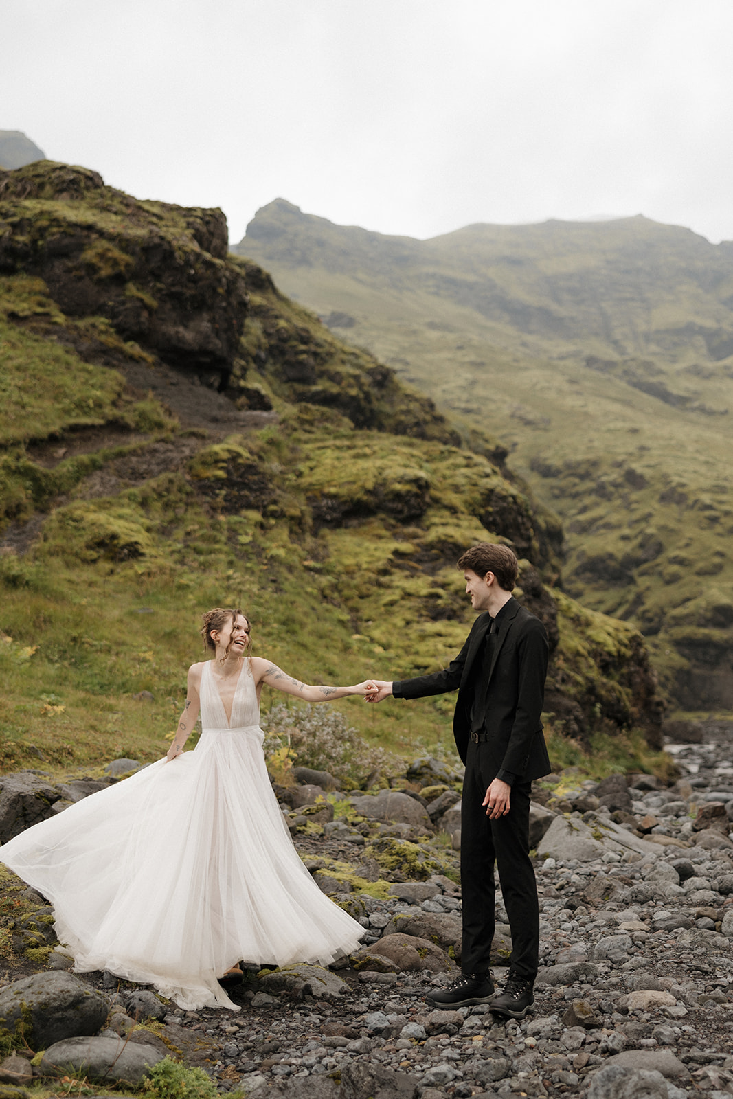 Bride and groom pose at Skogafoss during their Iceland elopement