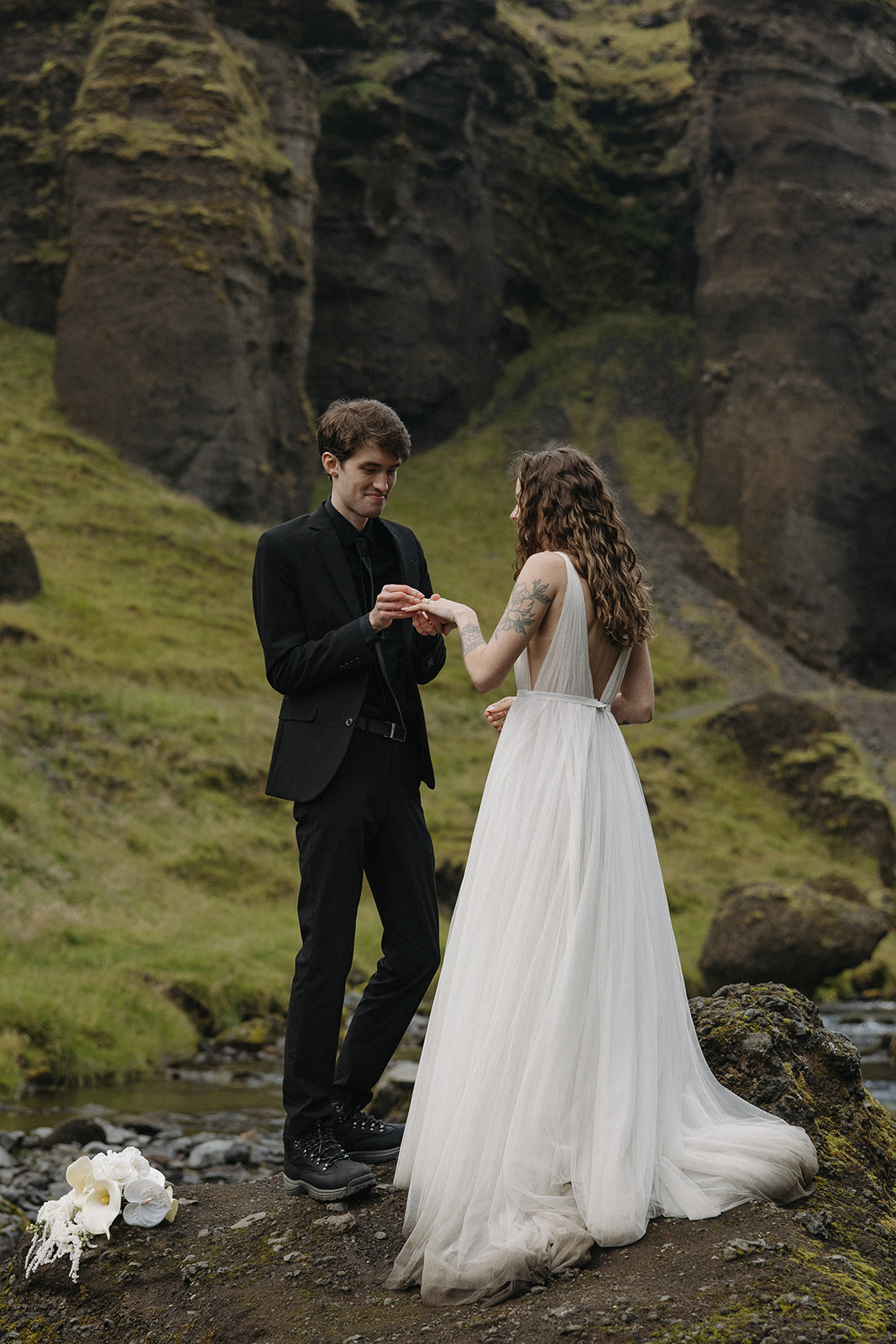 bride and groom take a moment to pose together in the Icelandic valley