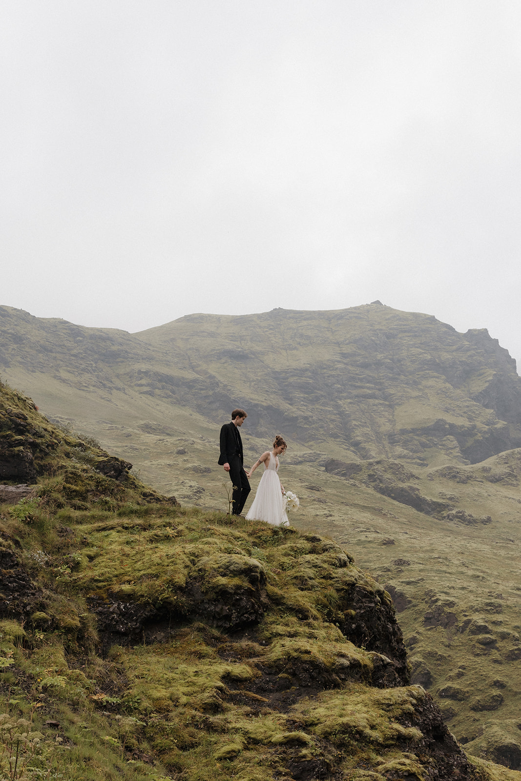 beautiful bride and groom pose in the Iceland nature after their Iceland elopement