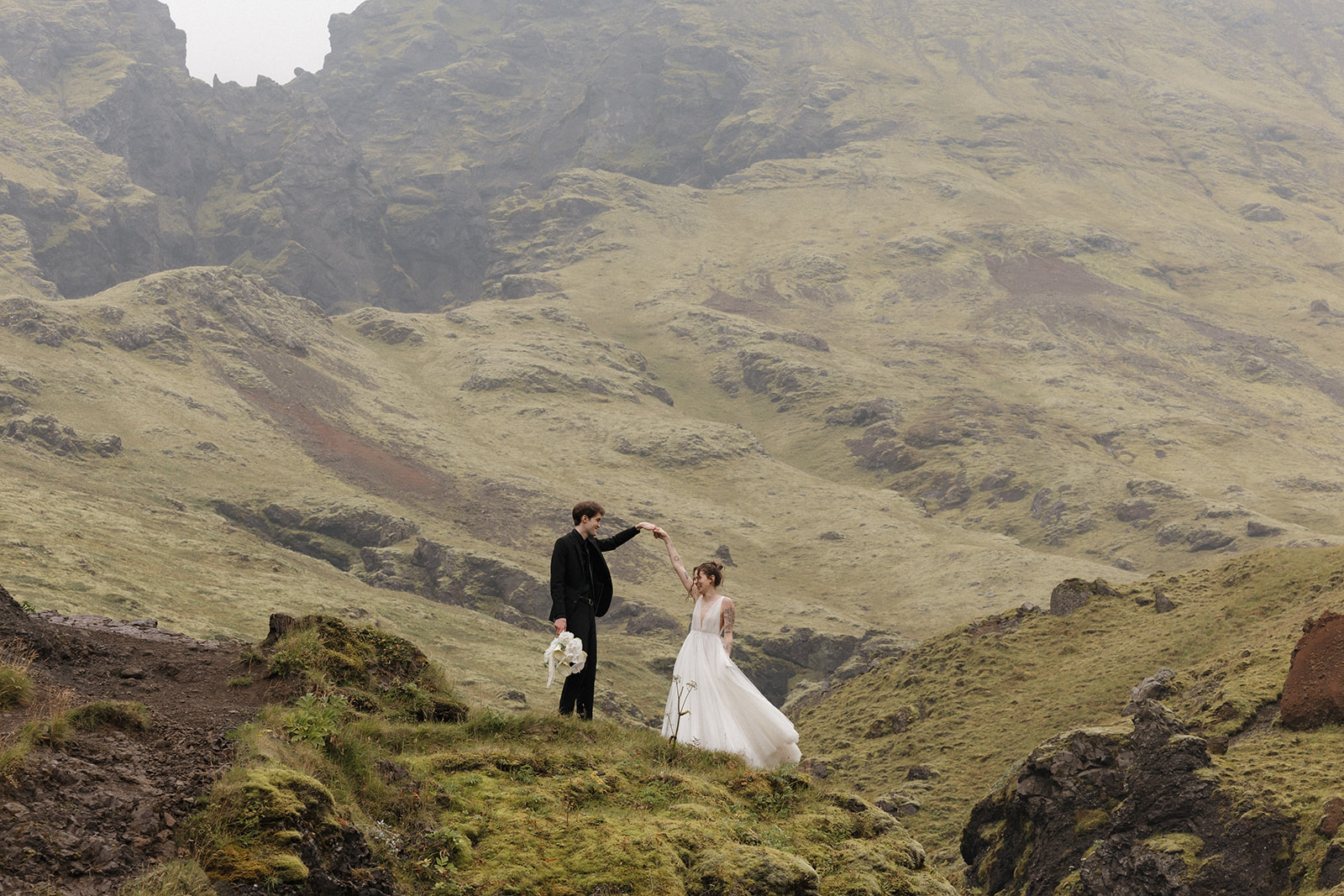 beautiful bride and groom pose in the Iceland nature after their Iceland elopement