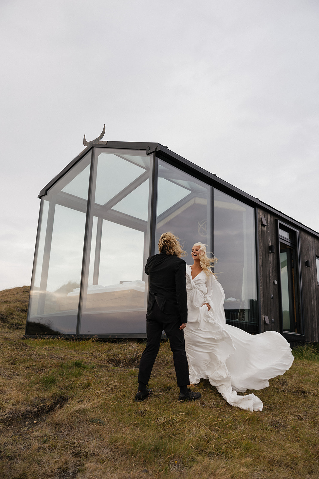 bride and groom share a first look outside of the glass house