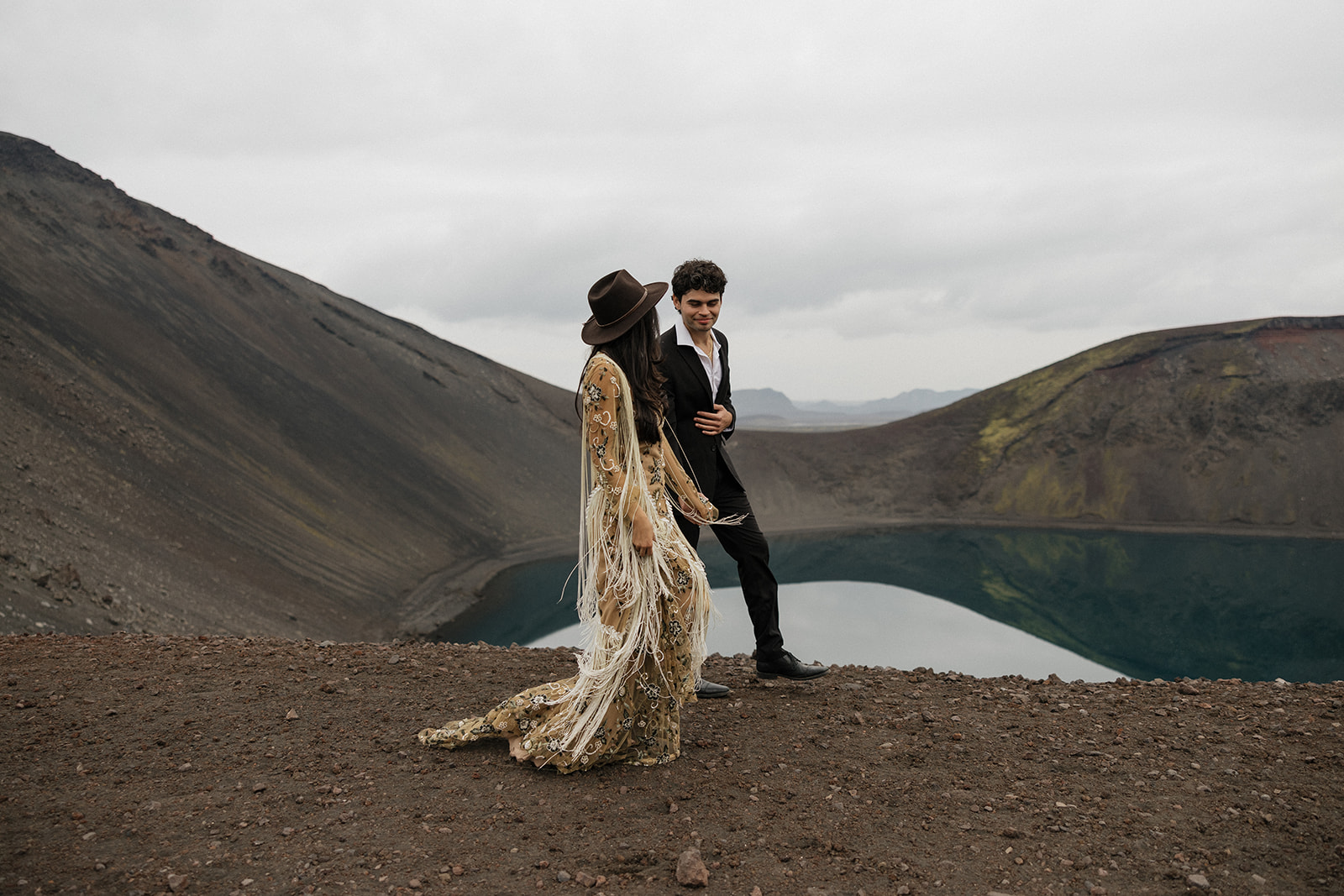 bride in tan bohemian dress pose with groom in iceland at the blue lagoon