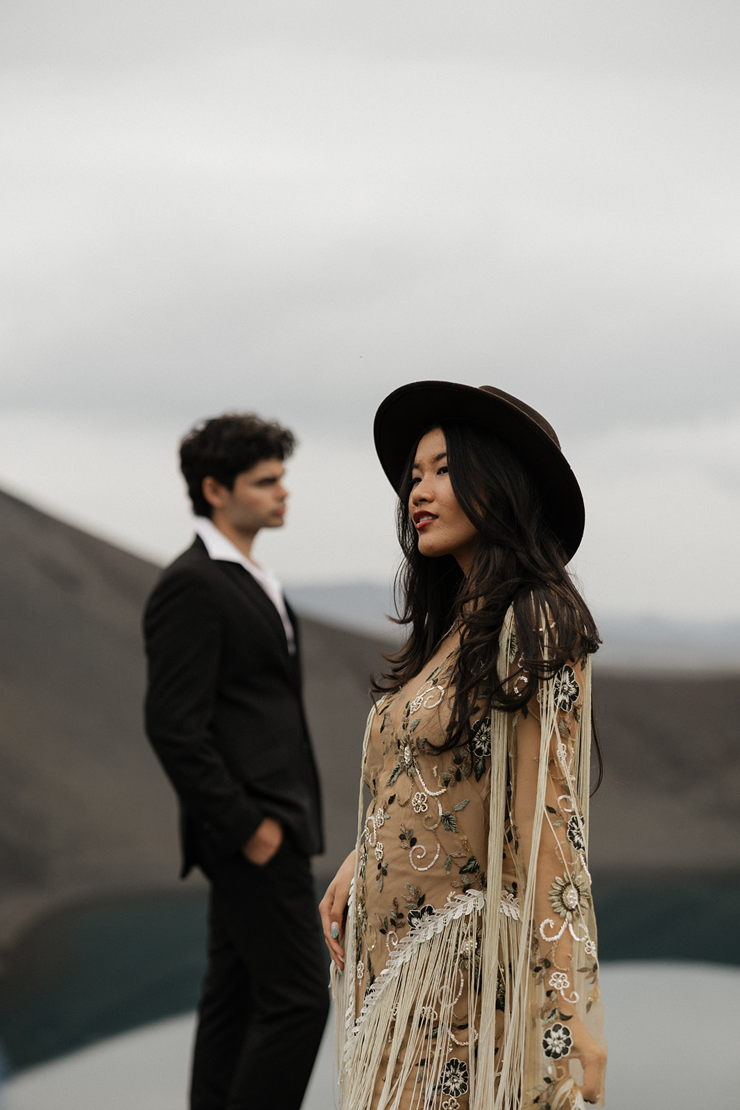 bride in tan bohemian dress pose with groom in iceland