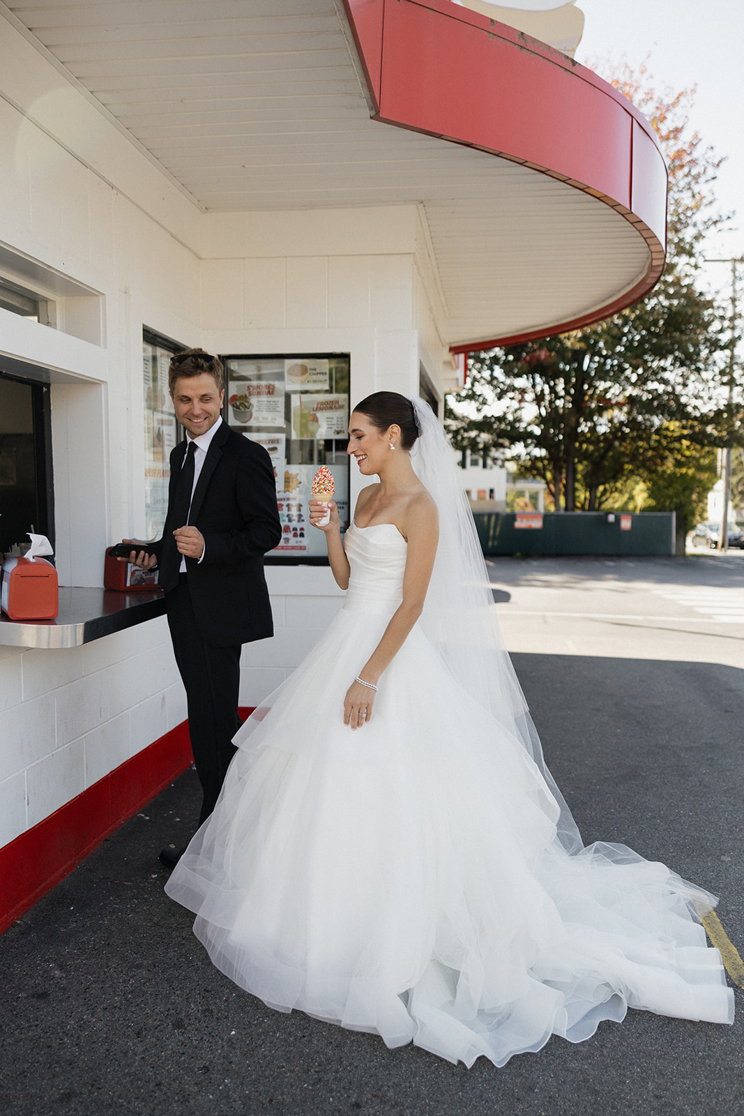 Candid photos of a bride and groom getting ice cream before their wedding in Portland, Maine