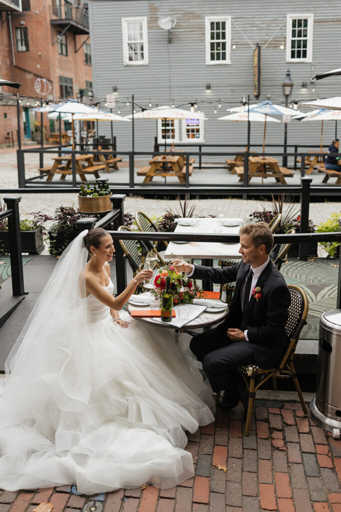 Bride and groom celebrating saying their vows at Via Vecchia in downtown Portland, Maine