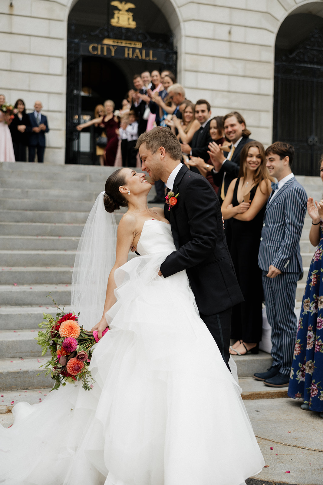 beautiful bride and groom pose for a photo after their Portland, Maine city hall wedding