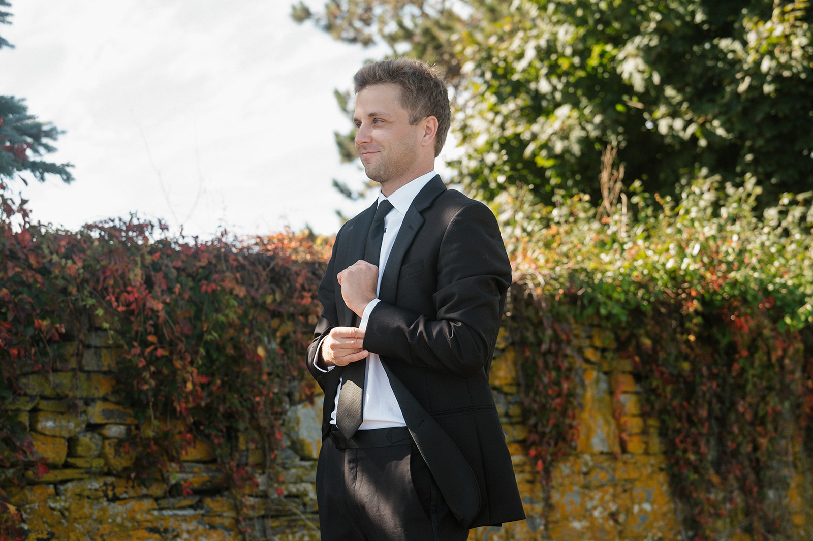 groom eagerly awaits his bride as they take first look photos at Willard Beach in Portland, Maine
