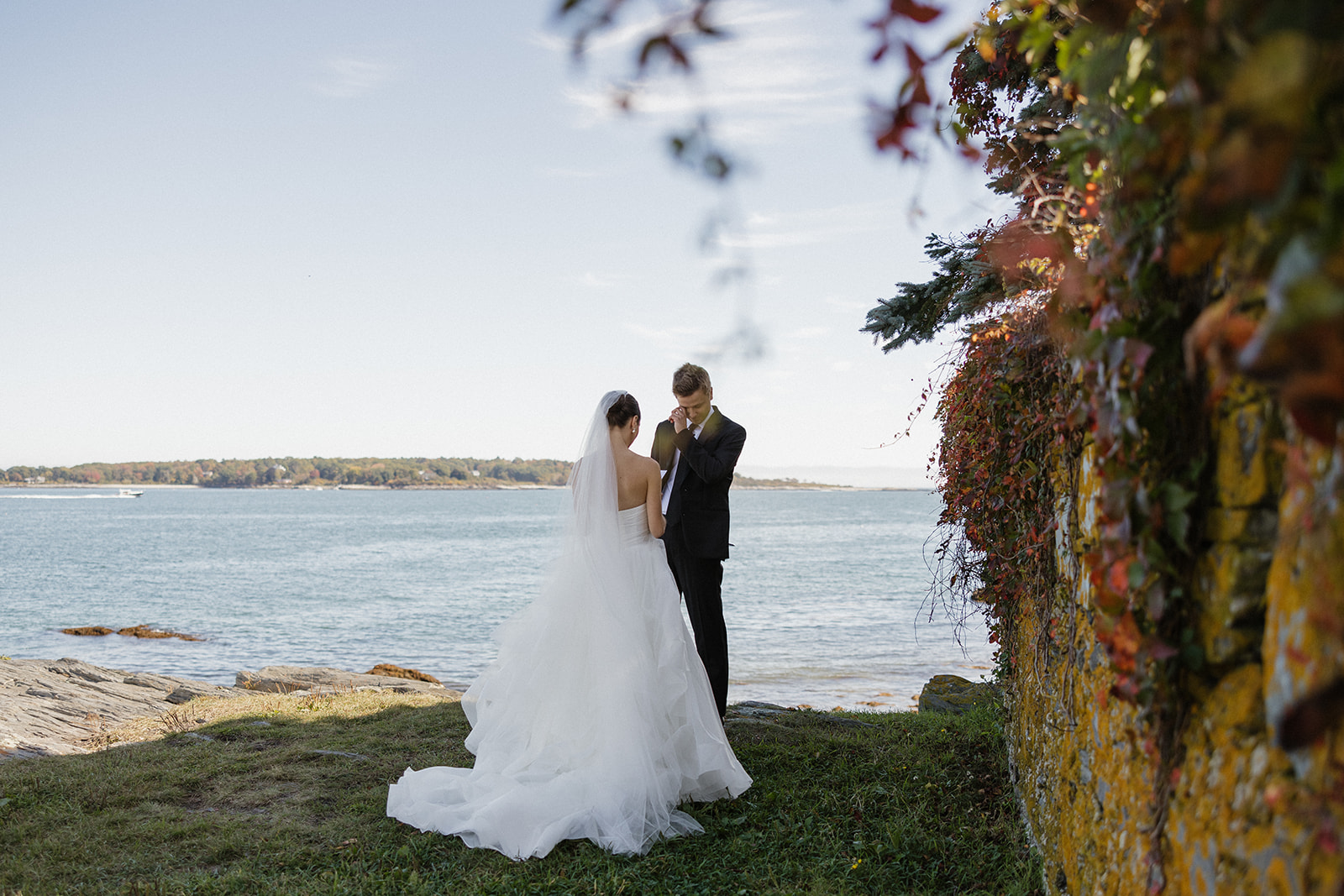 bride and groom share an intimate moment by the sea at Willard Beach in Portland, Maine
