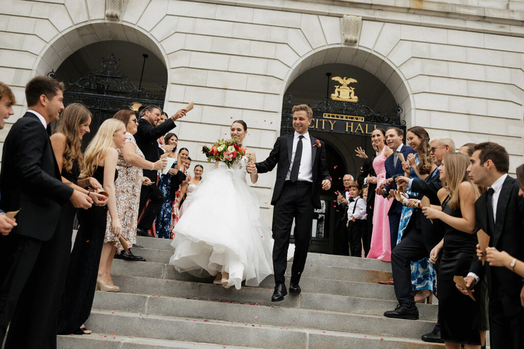 Bride and groom leaving Portland City Hall after their wedding in Maine