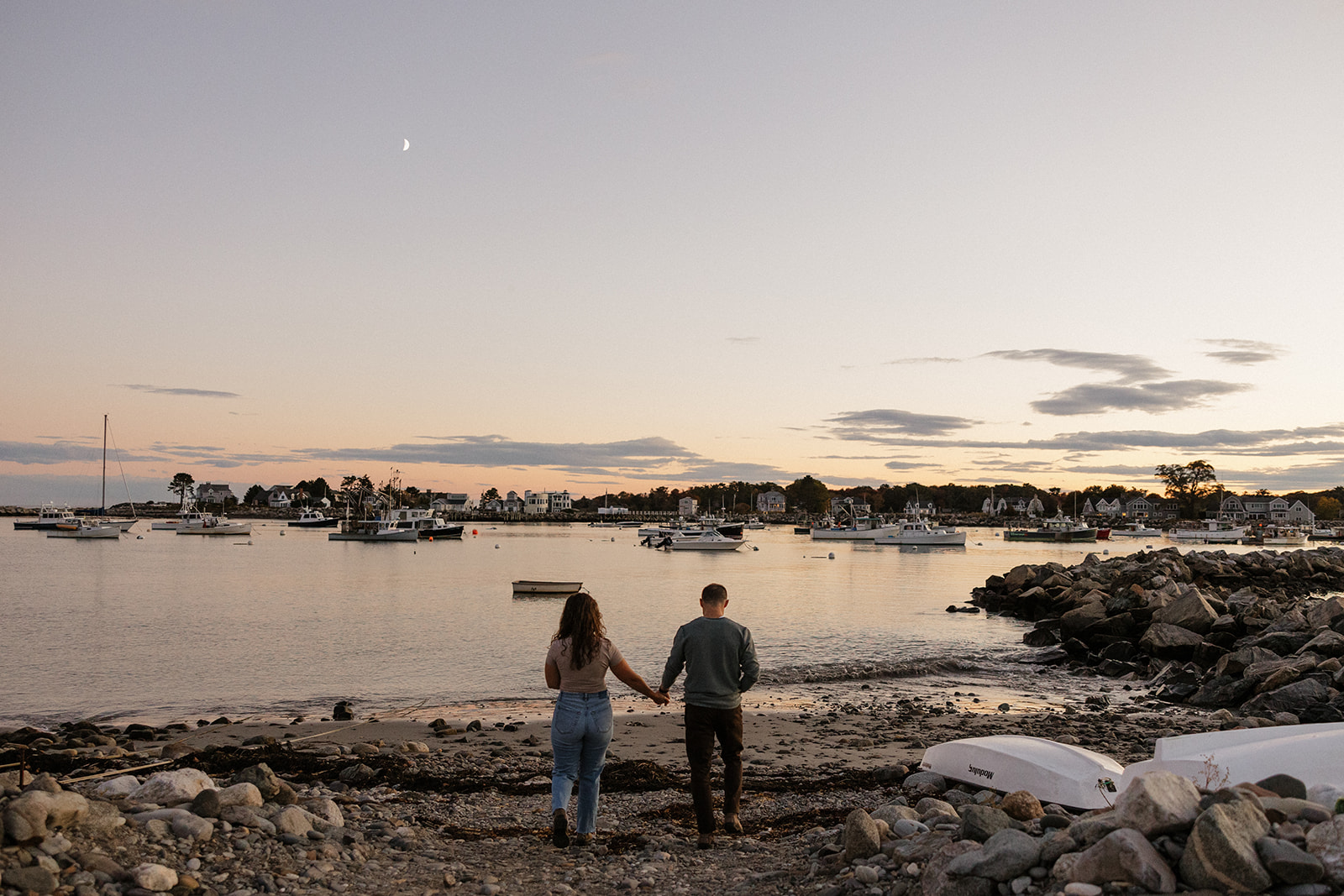 couple pose during sunset on wallis sands beach 