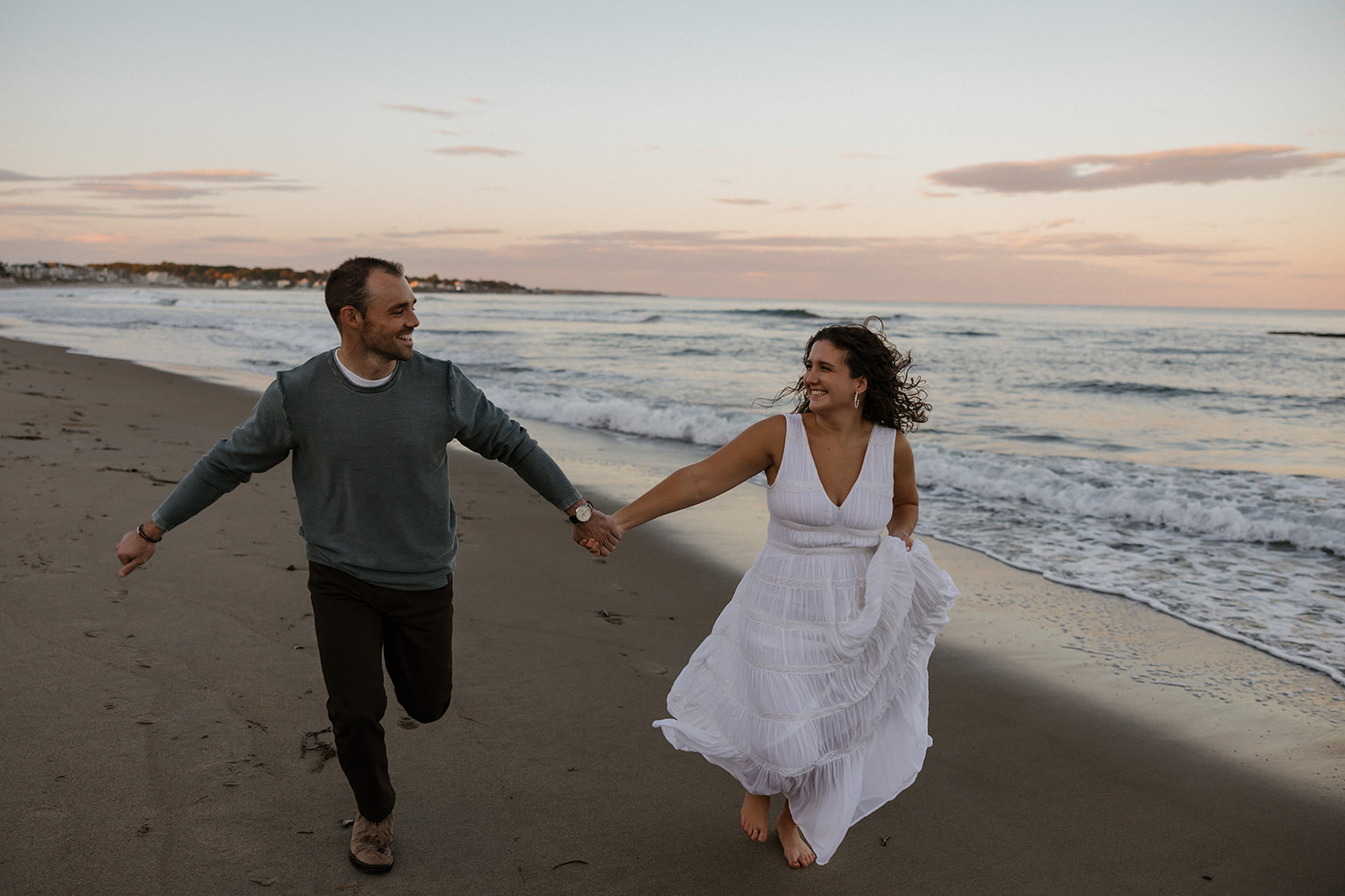 Couple run on pirates cove during their beach engagement pictures