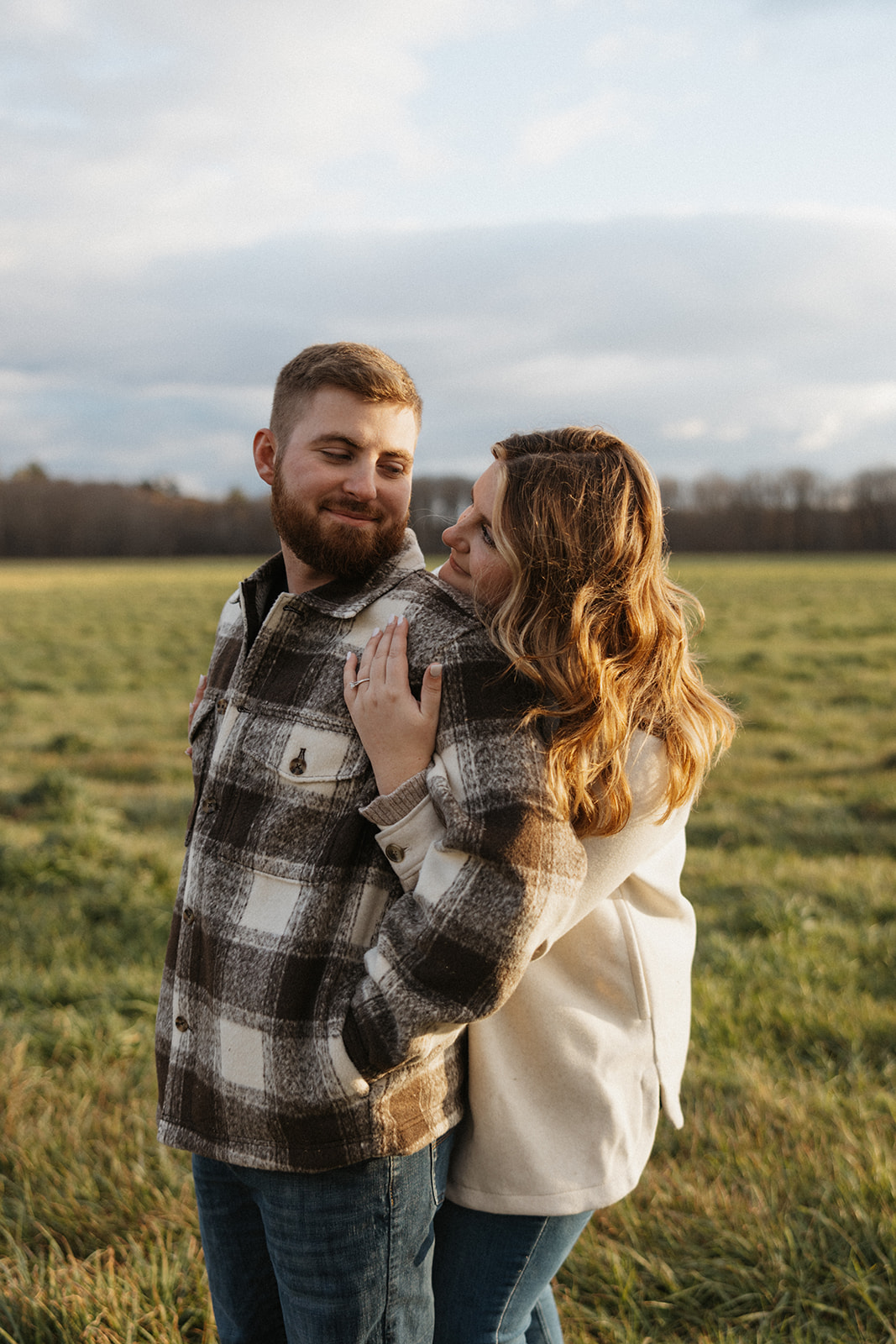 Candid and joyful New Hampshire mountain engagement session with playful couple.