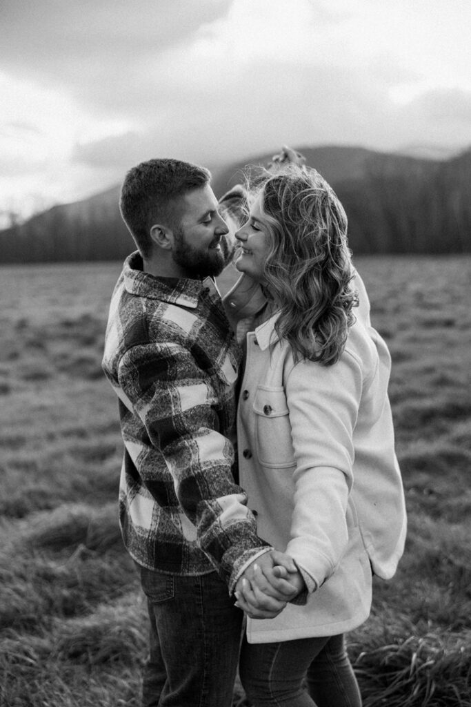 Natural and playful couple portraits in a field near Cathedral Ledge and Echo Lake