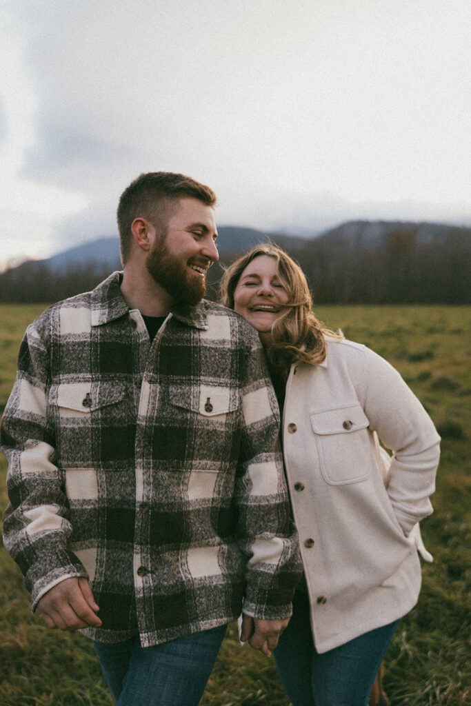 Candid couple laughing during their engagement session in North Conway, New Hampshire