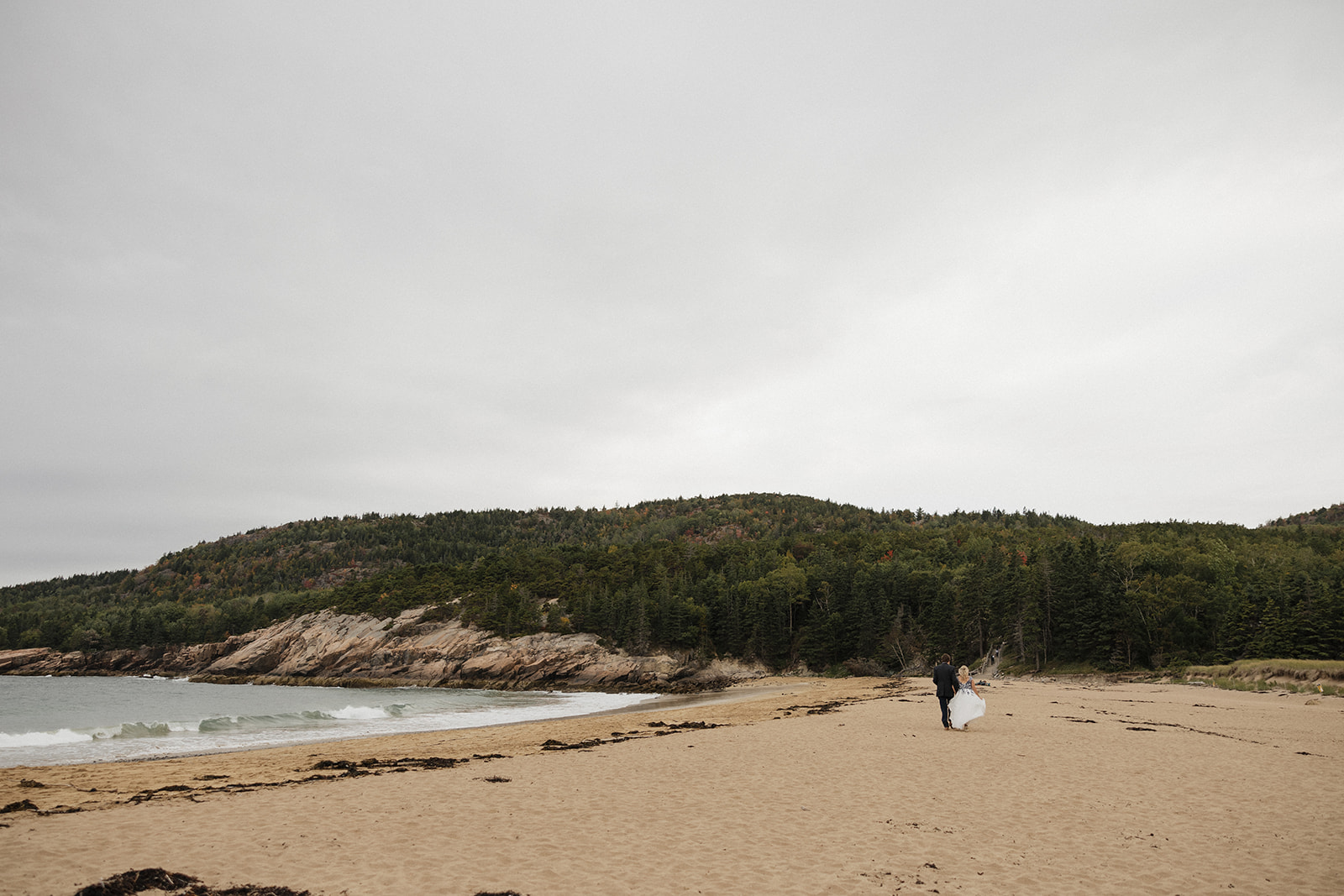 bride and groom share an intimate moment while walking on the beach, find my best advice on how to elope in maine here!