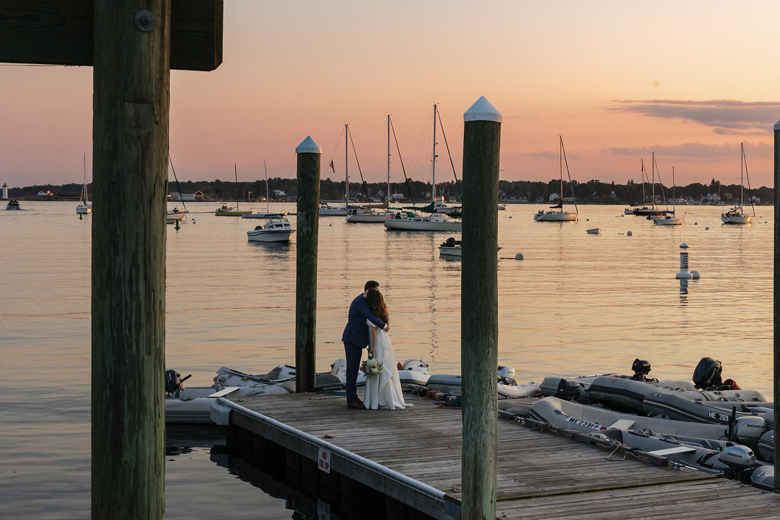 bride and groom share an intimate moment on the dock during their golden hour elopement