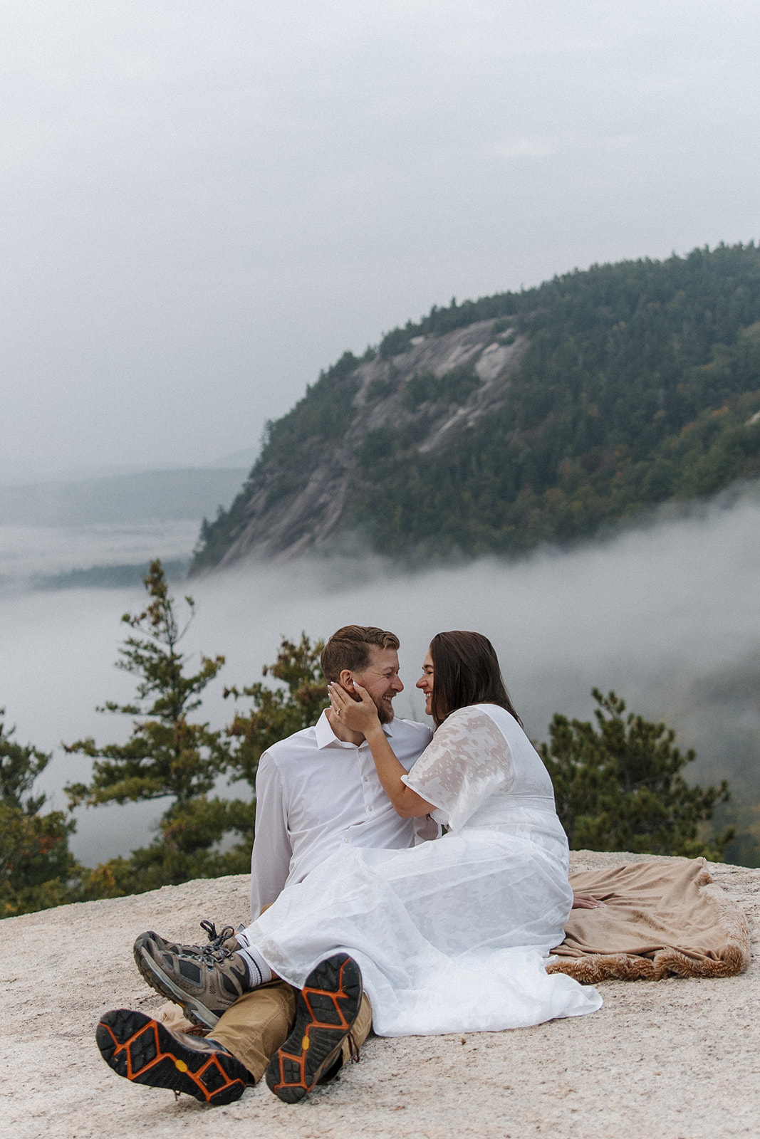 bride and groom pose on the edge of the mountain during their early morning elopement, one of the best times of the day to elope!