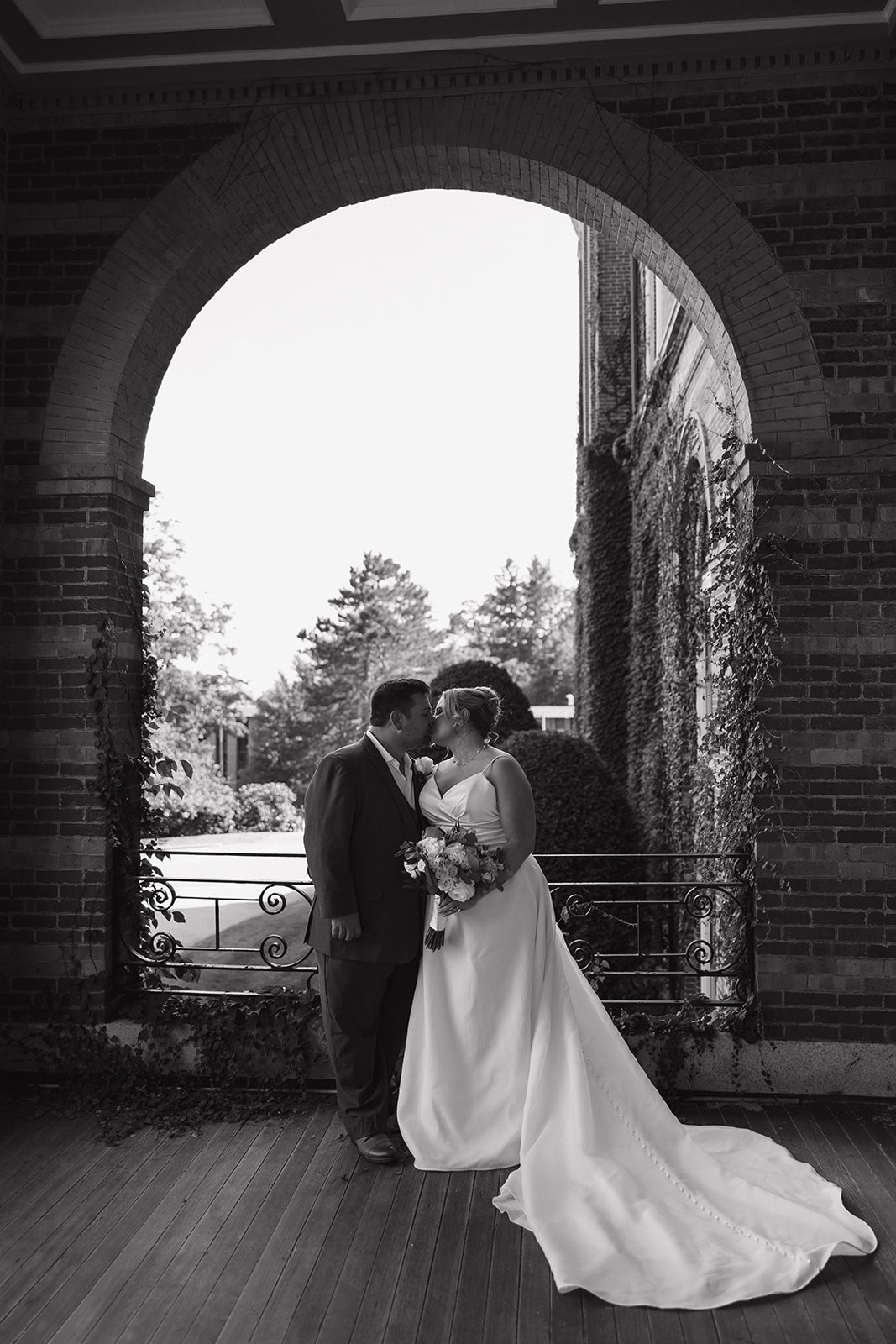bride and groom share a kiss during their wedding photography timeline