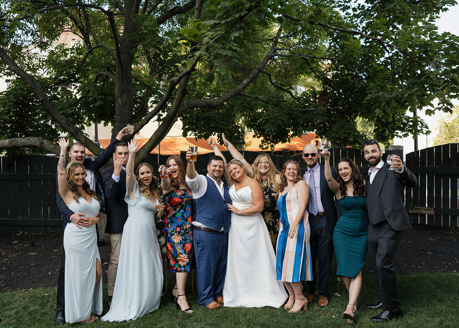 wedding party poses for a photo in the serene backyard