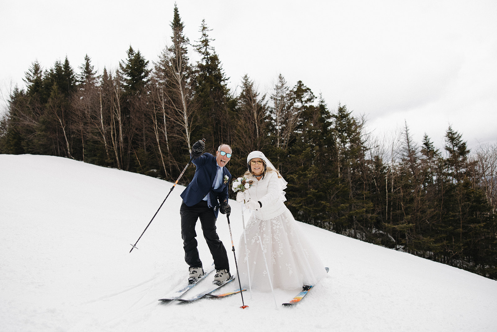 bride and groom share some fun skiing down the New Hampshire slopes on their wedding day