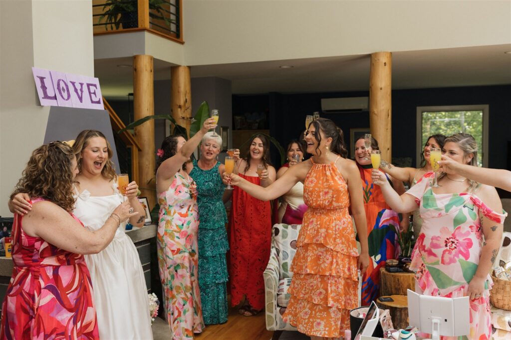 bride and bridesmaids celebrate with mimosas before the dreamy wedding day 