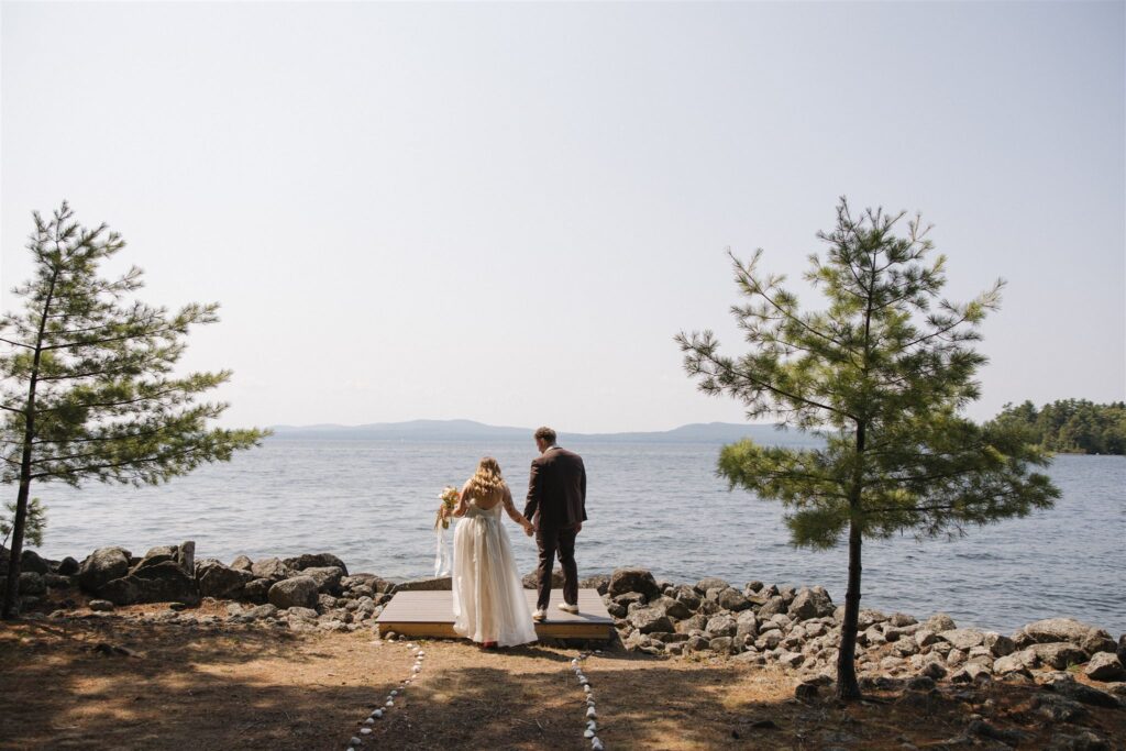 bride and groom walk to the ceremony site for one last look
