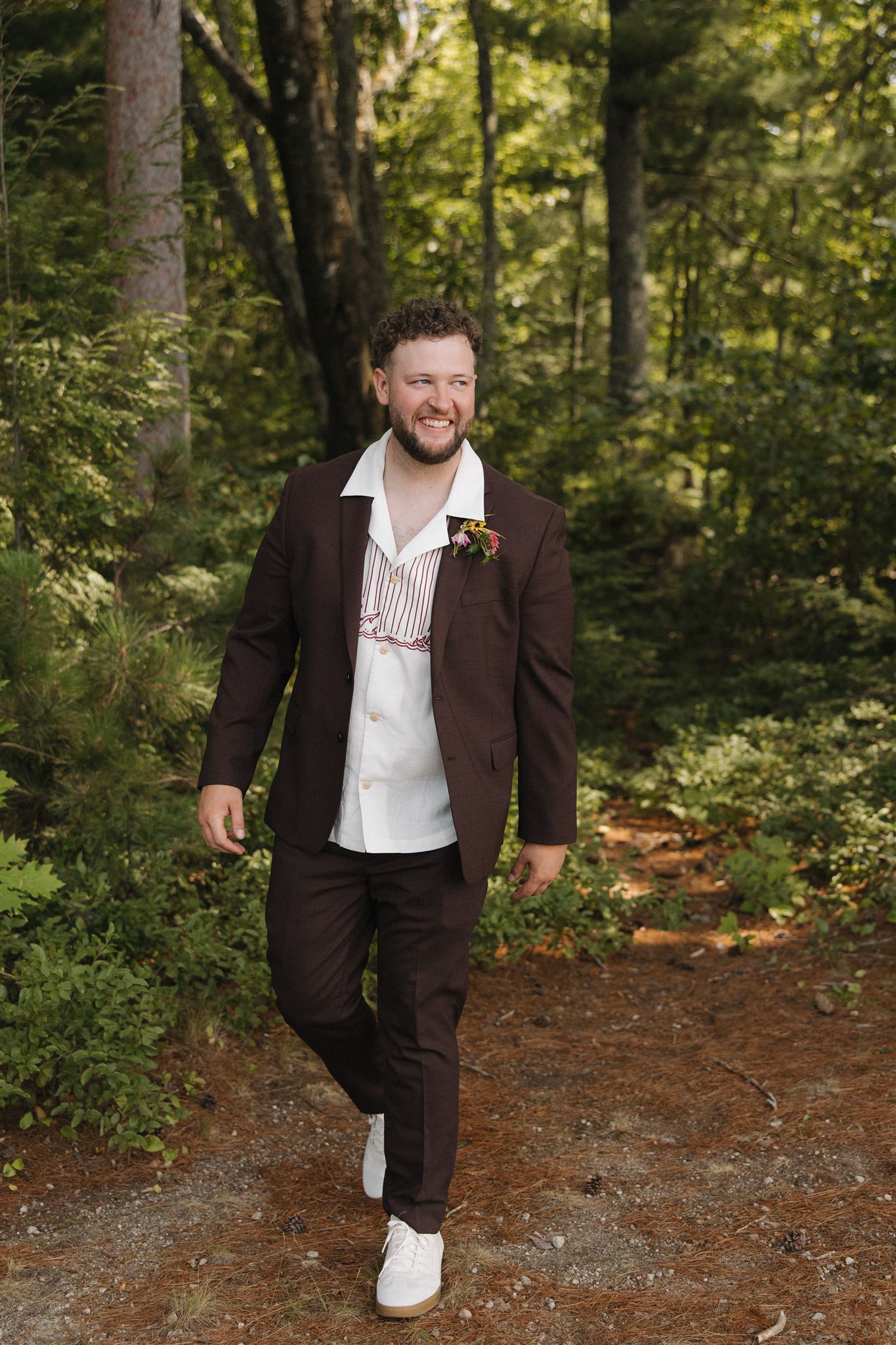 groom walks through the forrest