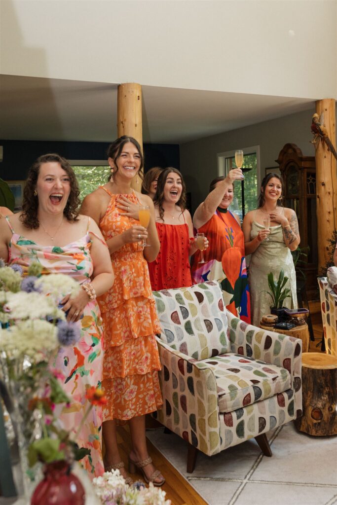 bridesmaids celebrate and cheer the bride on as they get their first look