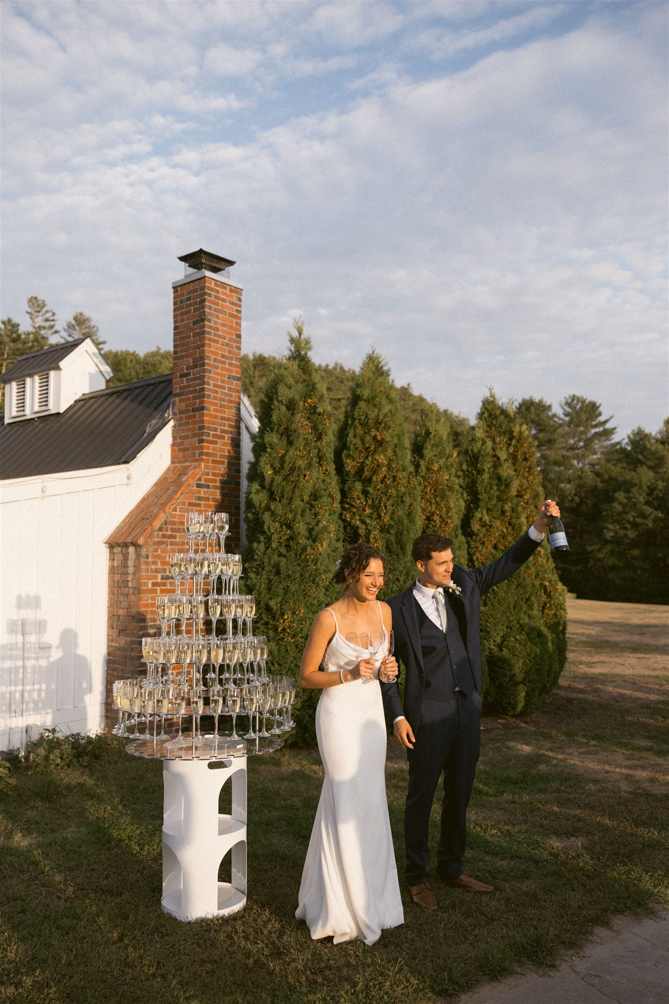 bride and groom give a toast and kick off the champagne tower