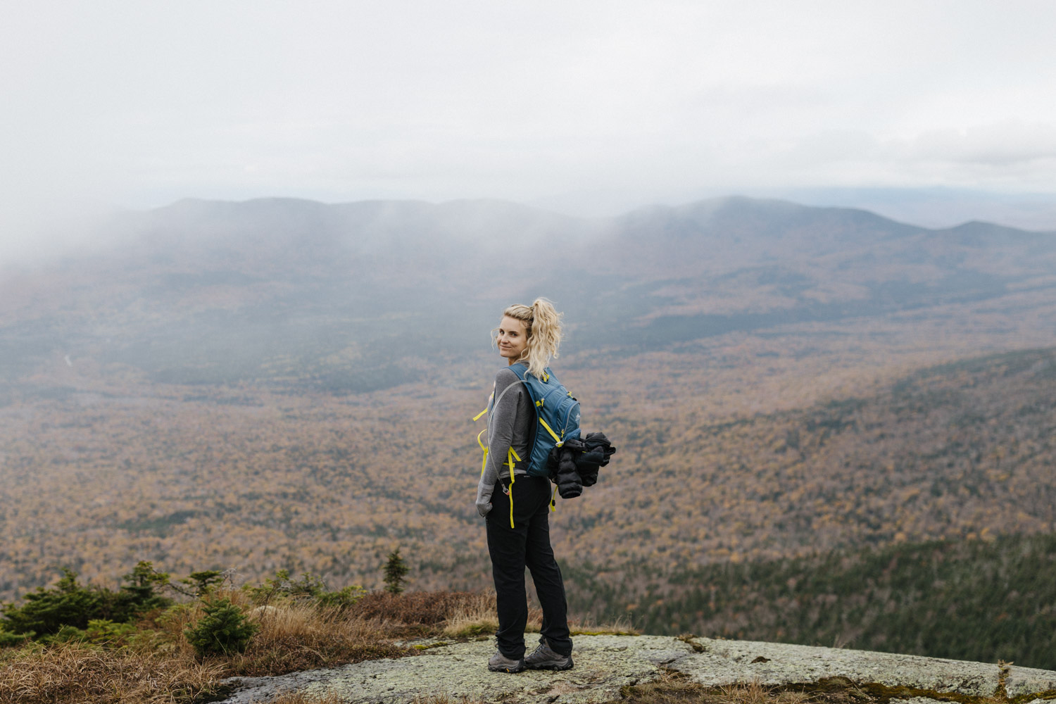 Erica poses for a photo with the New Hampshire wilderness in the background