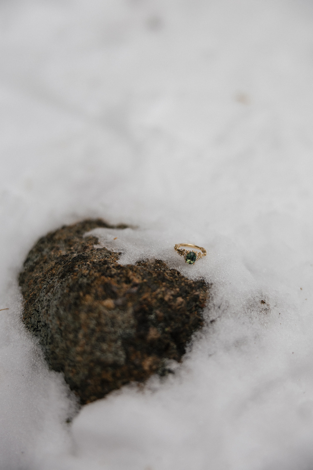 ring sits on a snowy rock during a surprise ski proposal